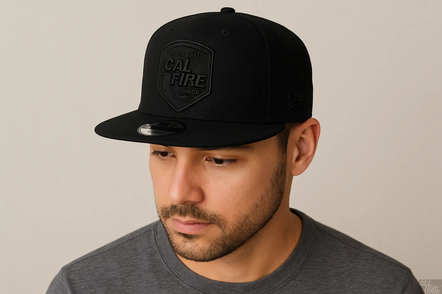 Person wearing New Era 403 Snapback Hat in solid black with blacked-out CAL FIRE shield logo showing comfortable fit and flat bill style