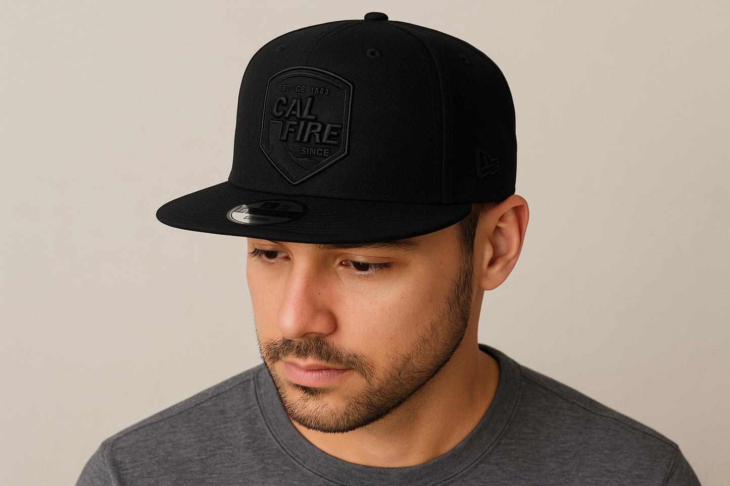 Person wearing New Era 403 Snapback Hat in solid black with blacked-out CAL FIRE shield logo showing comfortable fit and flat bill style