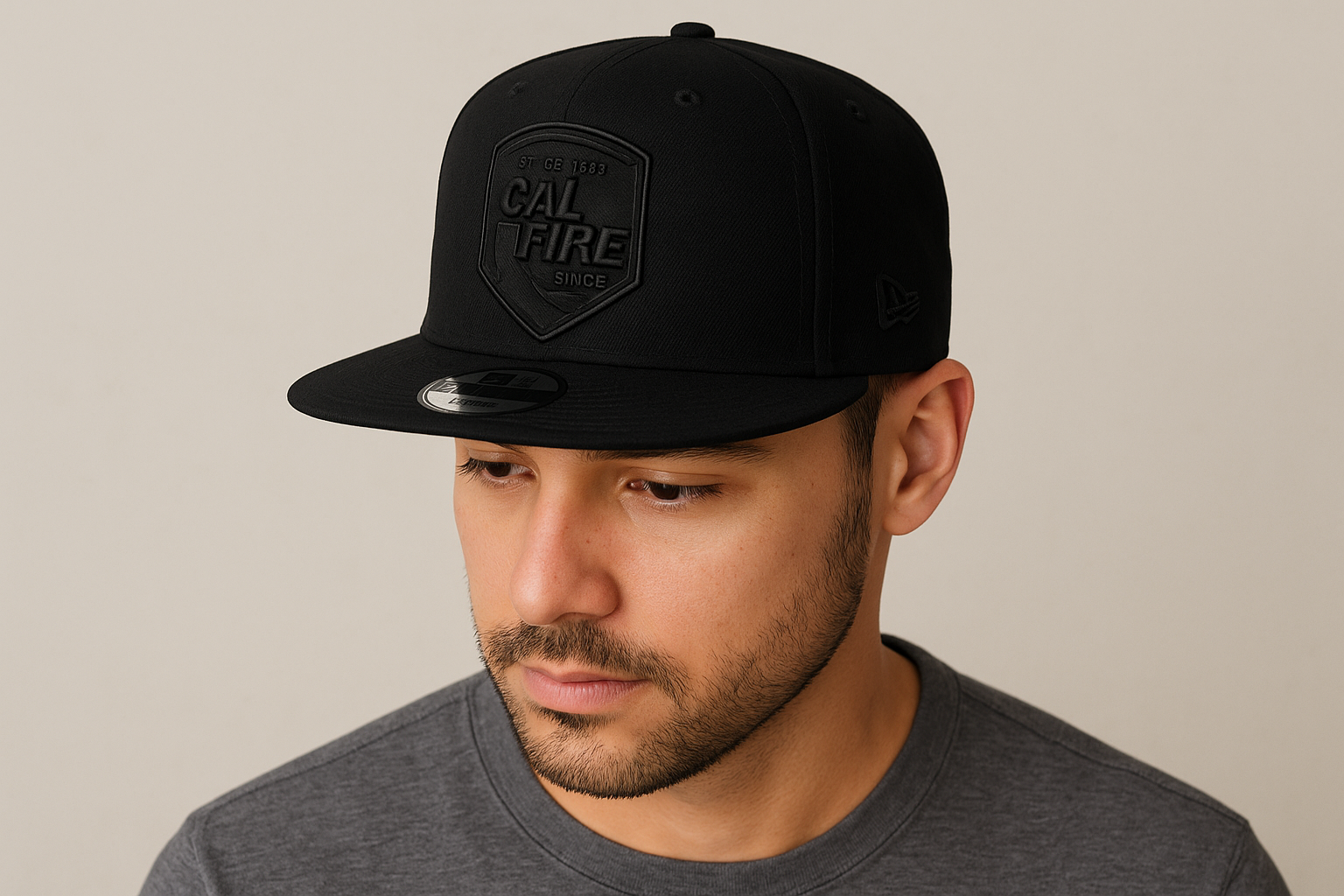 Person wearing New Era 403 Snapback Hat in solid black with blacked-out CAL FIRE shield logo showing comfortable fit and flat bill style