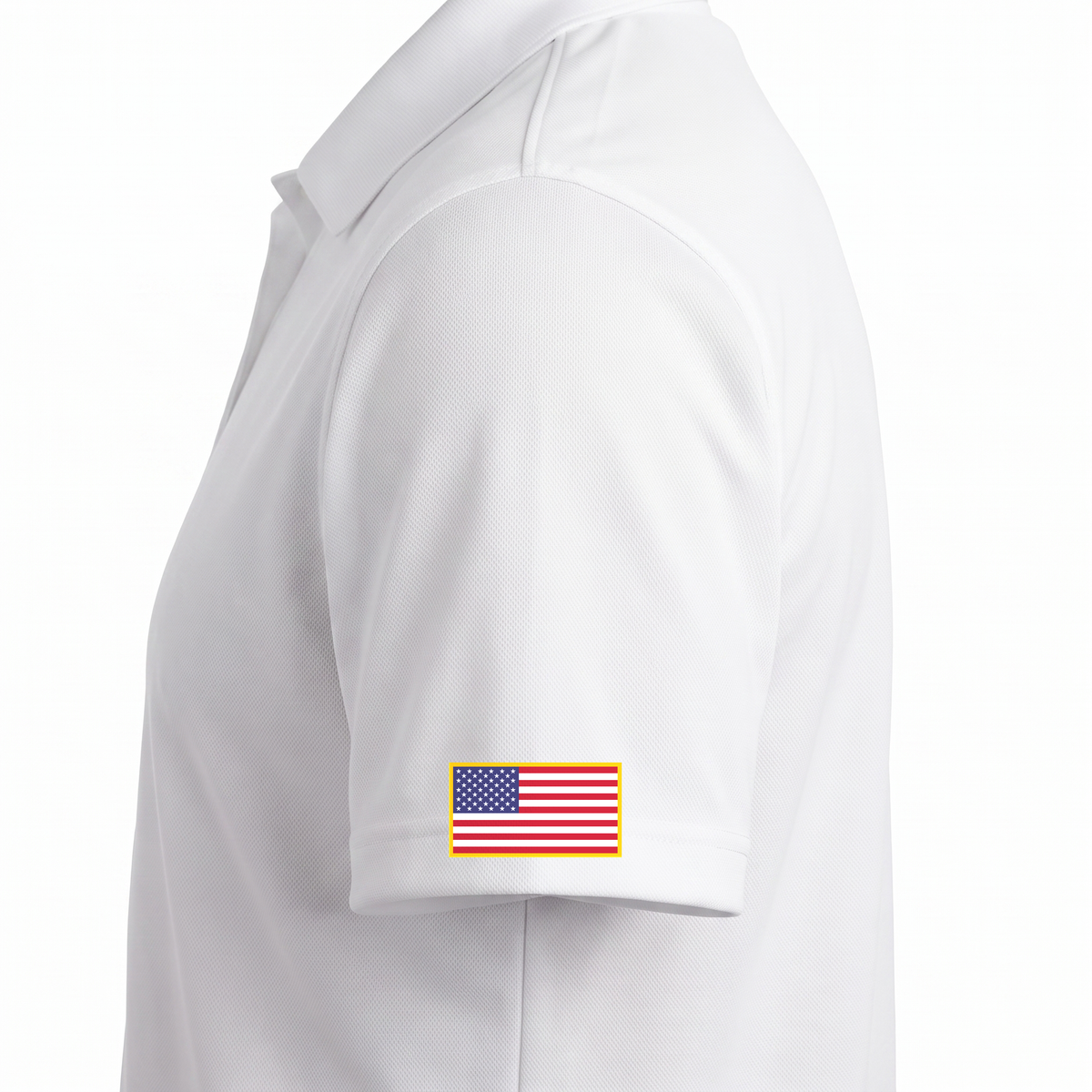 Siskiyou Trojans men's Sport-Tek polo in white, close-up of the left sleeve showing the United States flag patch just above the sleeve hem