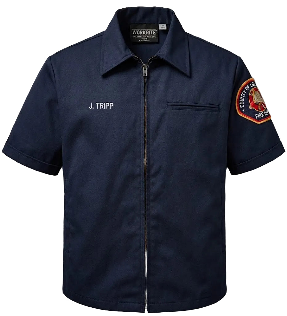 Navy short-sleeve shirt with 'J. Tripp' name and fire department patch on a gray background