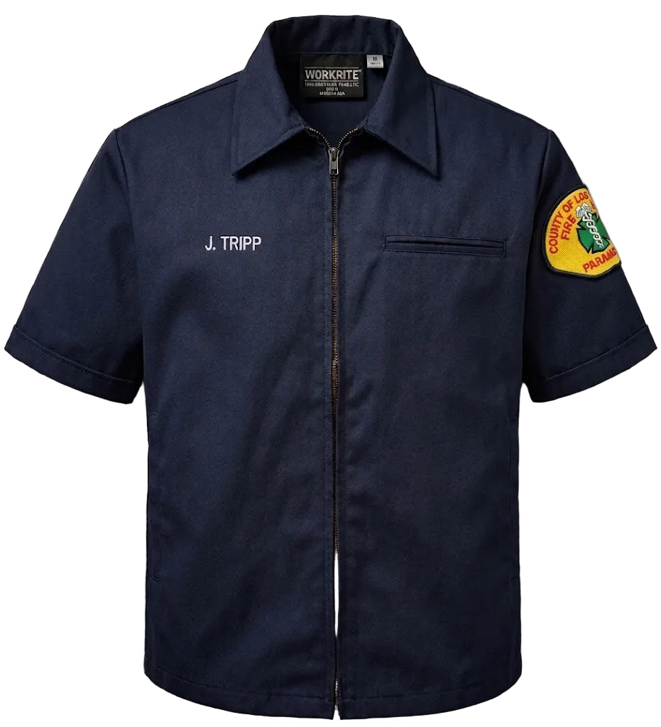 Navy blue work shirt with 'J. Tripp' name and patch on a gray background