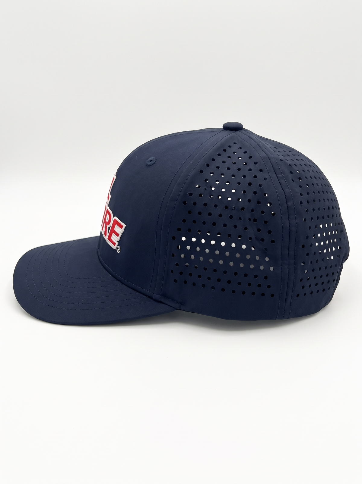 CAL FIRE 6-Panel Performance Hat, left side profile showing the laser-perforated vent panels, dark navy with red CAL FIRE wordmark with white outline (product render)