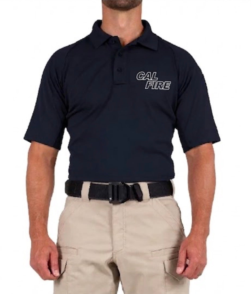Front view of a model in the navy polo showing a white-outlined stacked CAL FIRE wordmark on the left chest over khaki tactical pants.