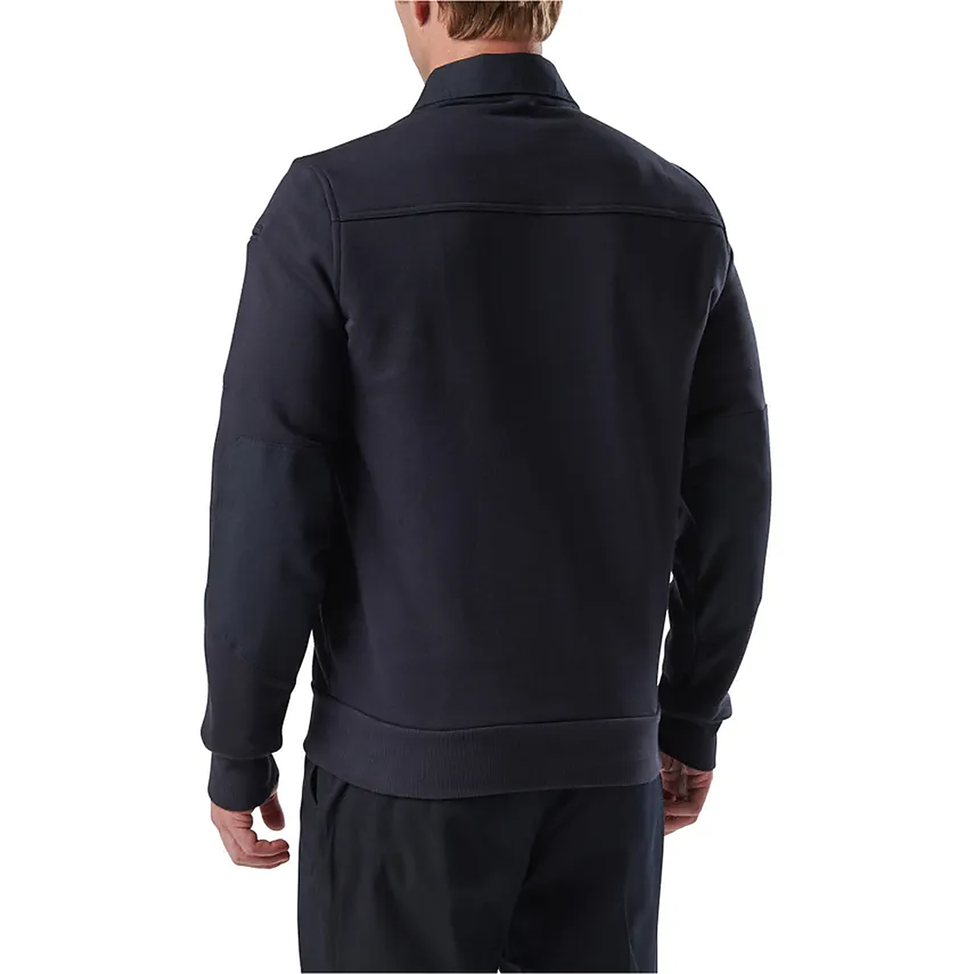 Rear three-quarter view of a model in the navy job shirt, capturing the side seam and drop shoulder.