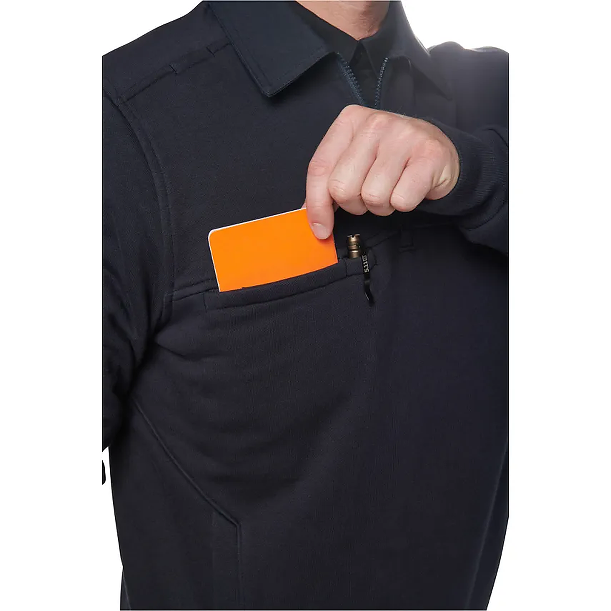 Close-up of the zippered chest pocket on the navy job shirt with an orange phone tucked inside to show pocket depth.