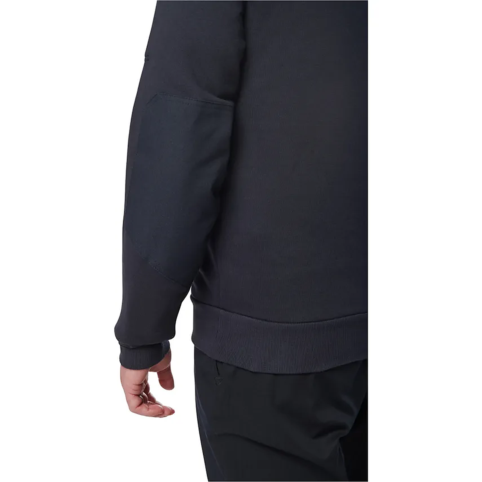 Close-up rear three-quarter view of a model in the plain navy job shirt, showing the ribbed cuff and elongated back hem.