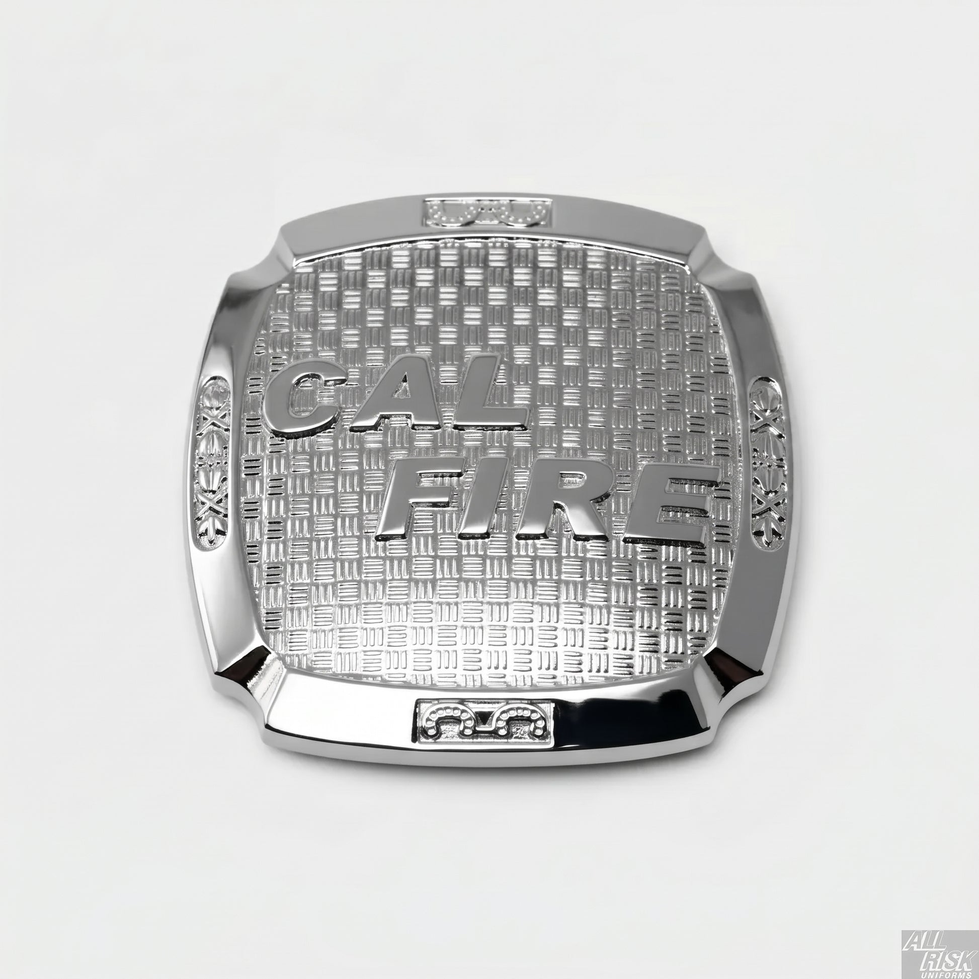 CAL FIRE silver belt buckle — single chrome-finish buckle on white background, raised CAL FIRE text on a basket-weave textured field, scrollwork accents at left/right corner panels, and ornamental frames at top and bottom centers.