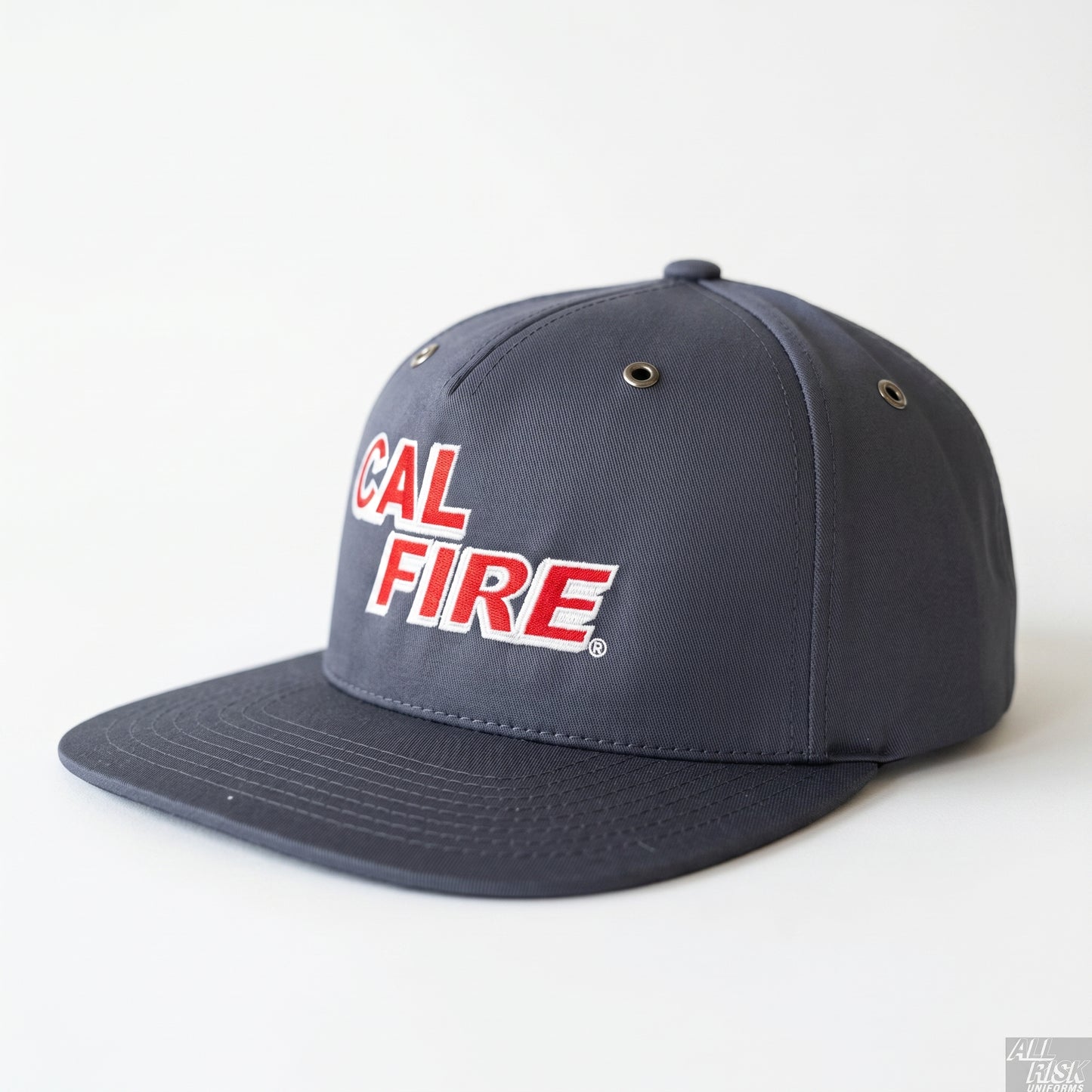 CAL FIRE Bucket Brigade flat-bill cap in charcoal-navy, front three-quarter view — red CAL FIRE block wordmark with white outline, metal side vents and a flat brim.