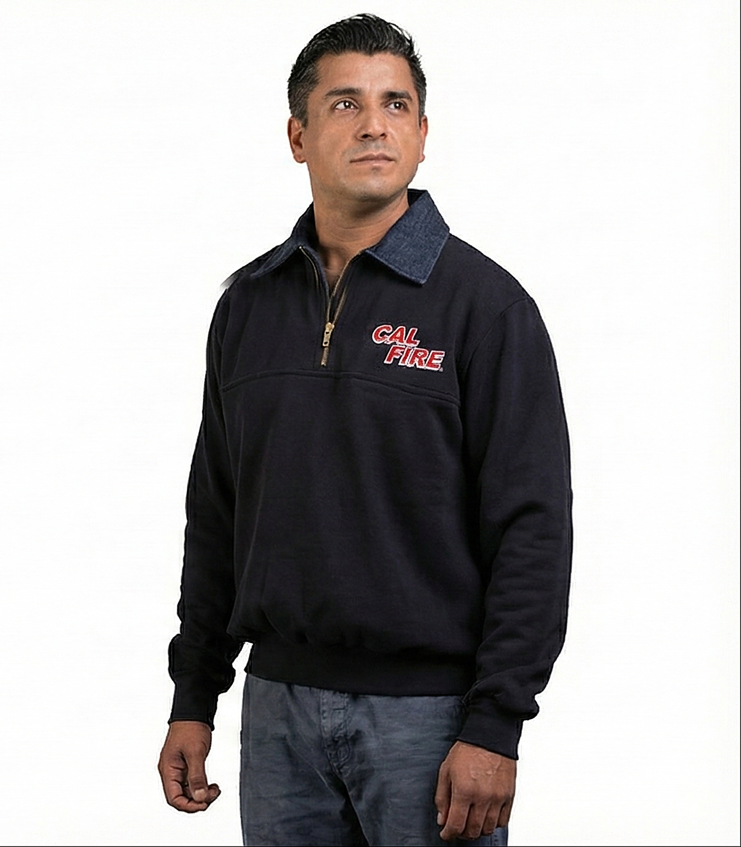 Male model turned slightly, navy job shirt with denim collar and gold zipper, red CAL FIRE wordmark across the left chest.