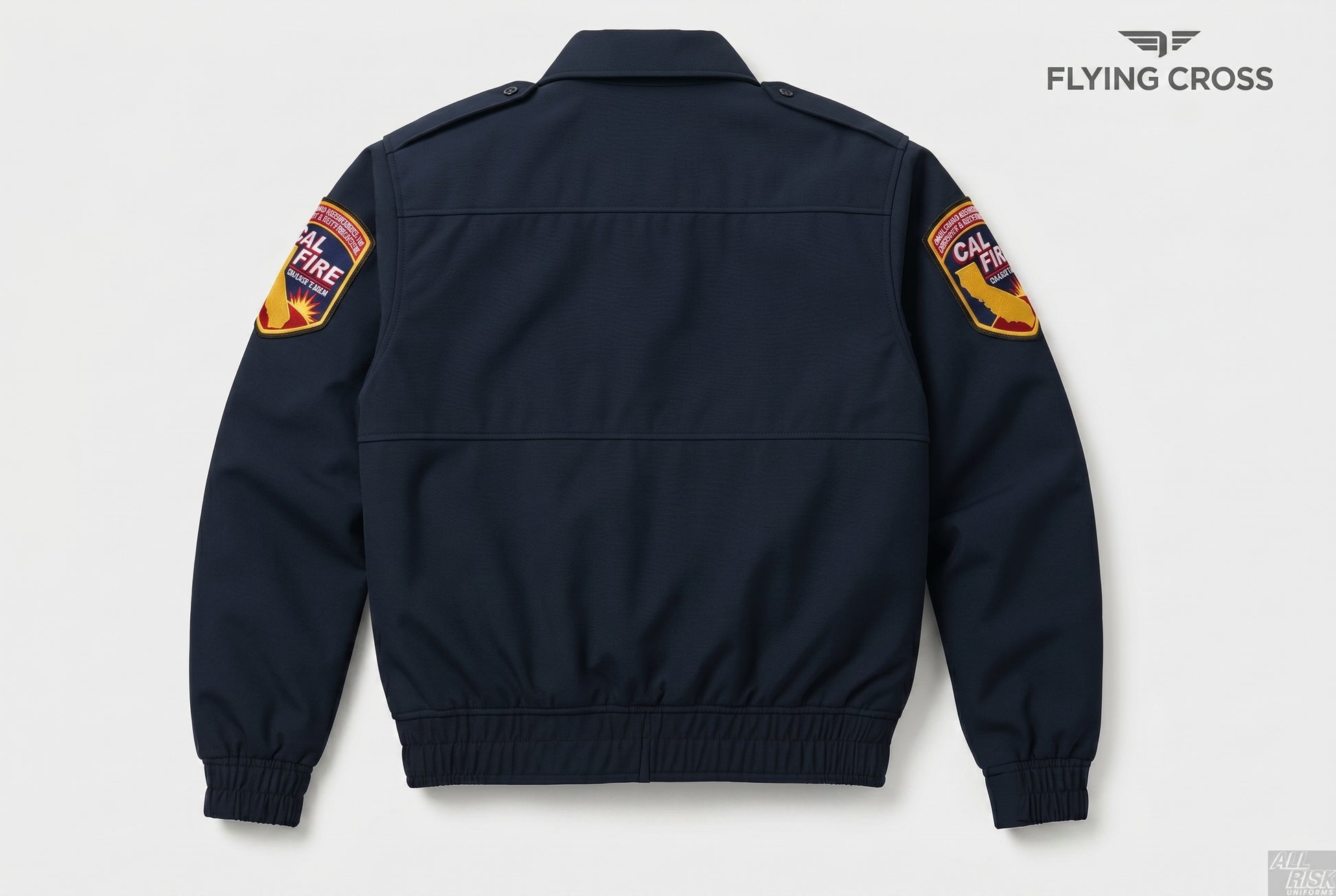 CAL FIRE Flying Cross 2-in-1 duty jacket — back view in midnight navy showing the clean back panel with horizontal back yoke seam, both CAL FIRE shoulder patches, and ribbed elastic waistband and cuffs. Flying Cross logo watermark in the top-right corner.
