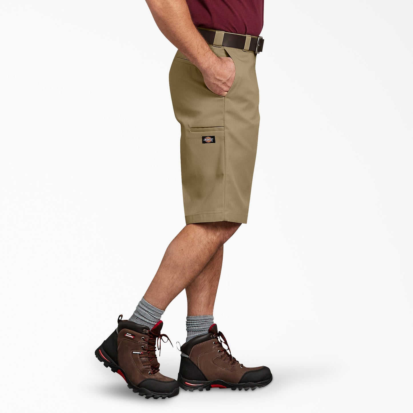 Side view of a man wearing Dickies Khaki relaxed-fit work shorts, showing the side utility leg pocket with Dickies logo tab
