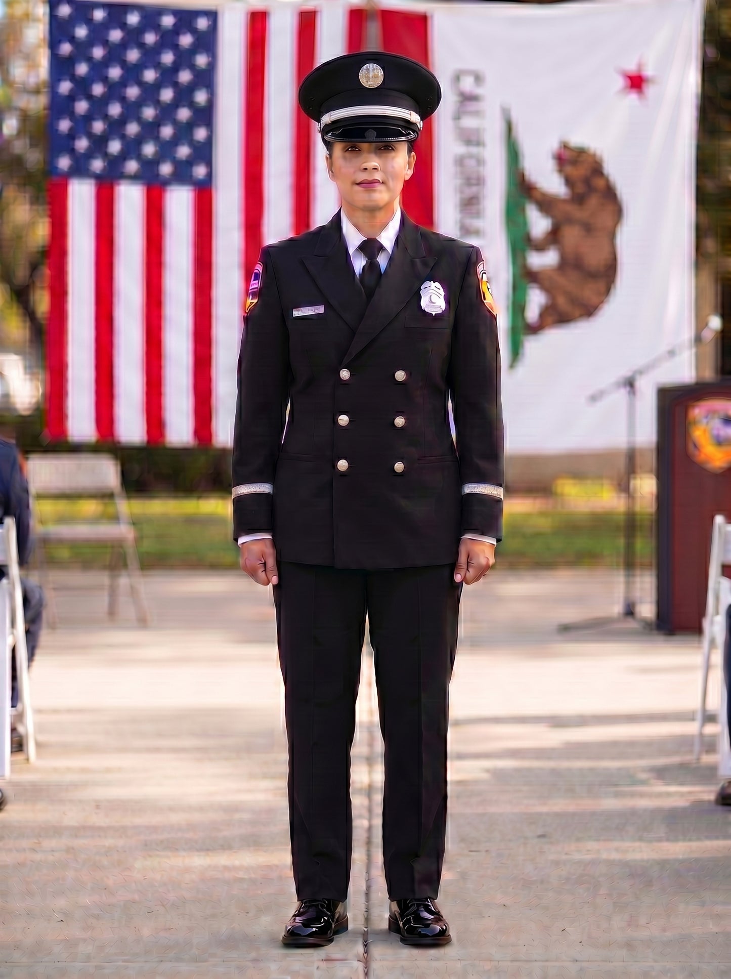 Female CAL FIRE firefighter in Class A dress uniform at graduation ceremony