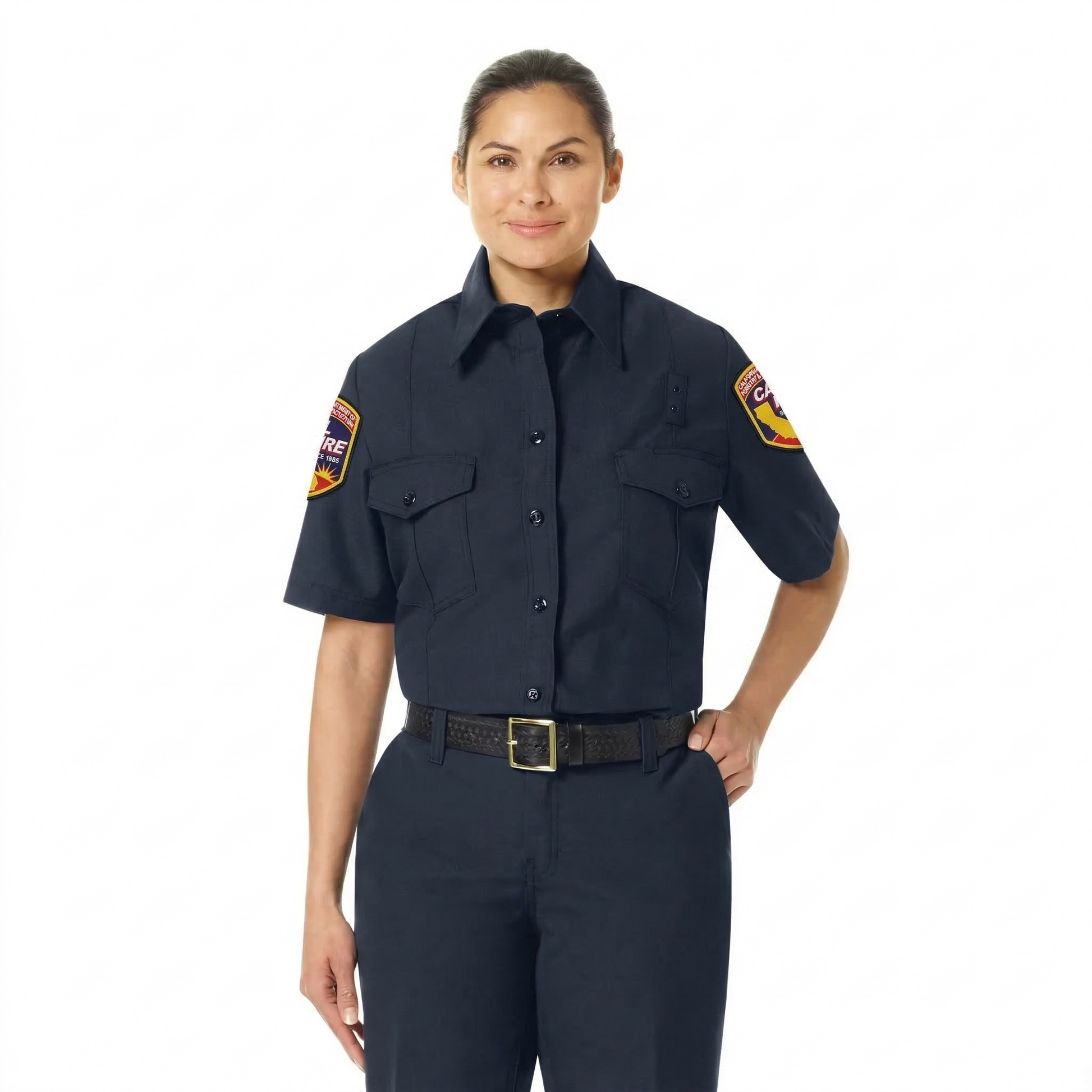 Female model facing forward in the navy women's Nomex short-sleeve uniform shirt with badge tabs, flap pockets, and CAL FIRE arrowhead patches on both sleeves.