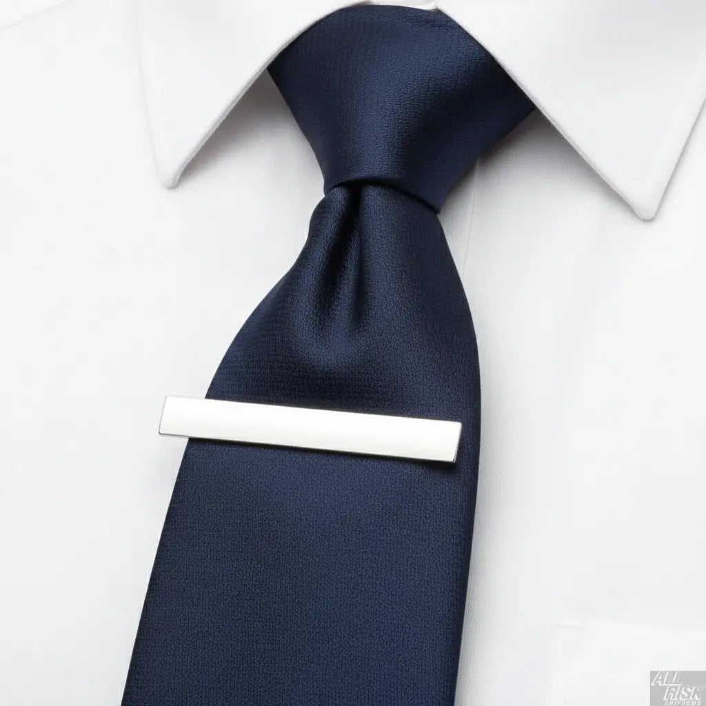 Hero's Pride Tie Bar in Use - Silver Clip Securing Navy Blue Uniform Tie - Professional Law Enforcement Firefighter CAL FIRE Accessory - Functional Product Photography