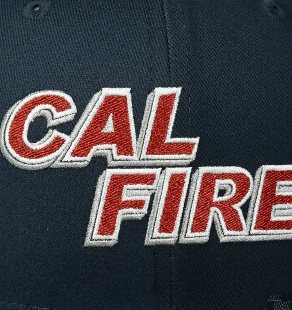 Close-up detail of red CAL FIRE embroidered text on New Era 403 snapback hat showing premium stitching quality and craftsmanship