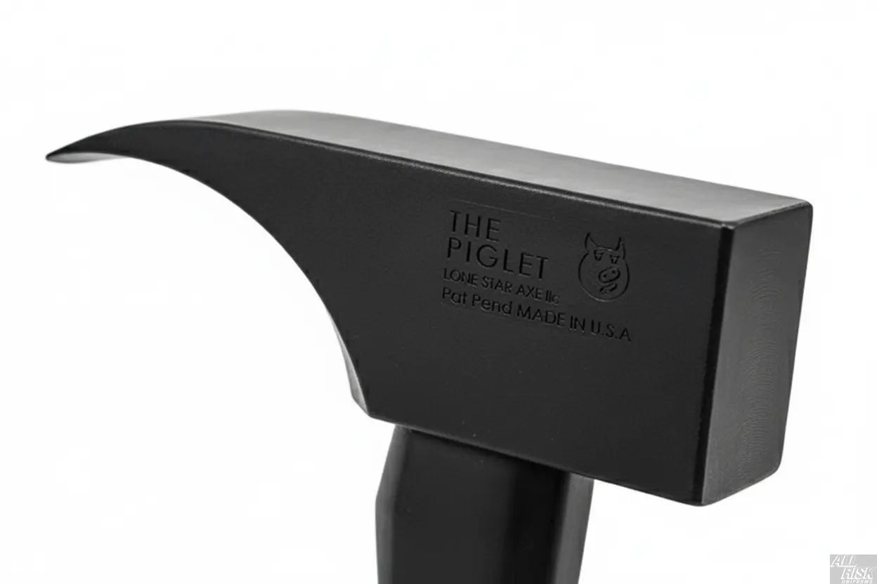 Close-up detail of PIGlet tool head showing 6lb tool steel construction with black oxide finish and striking surfaces