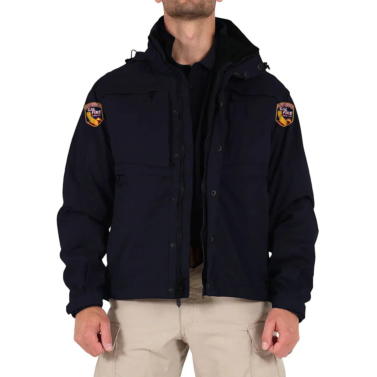 Model wearing the navy CAL FIRE First Tactical Tactix System Jacket open over the softshell liner, CAL FIRE shoulder patches on both sleeves.