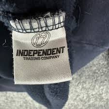 Close-up of the inside neck label reading Independent Trading Company on the navy fabric, identifying the shirt's blank brand.