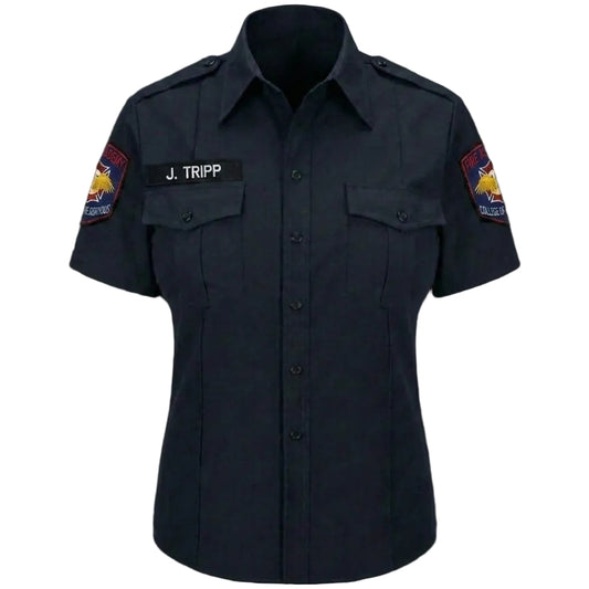Dark blue shirt with patches and a name tag on a black background